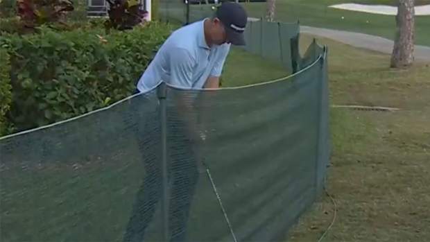 Justin Rose lines up for a difficult shot.